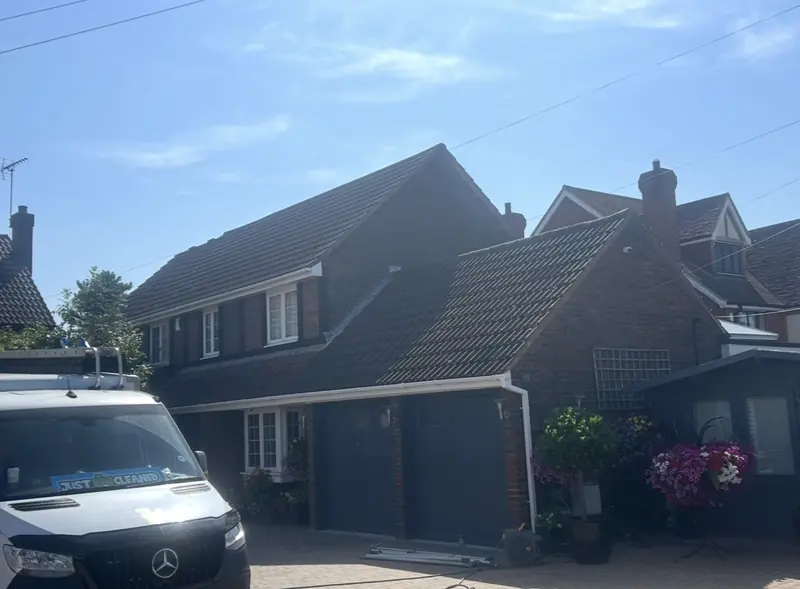 Detached house with a white van on the drive and hanging baskets