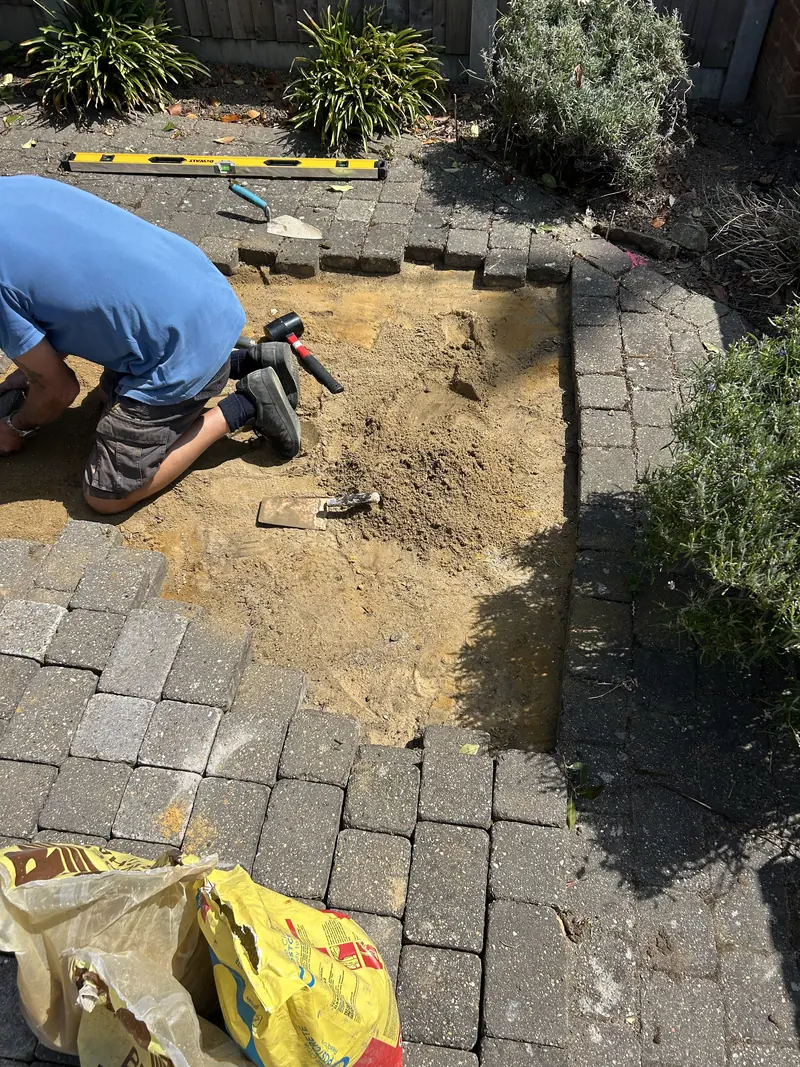 Block paving lifted and relaid on sand during a driveway repair