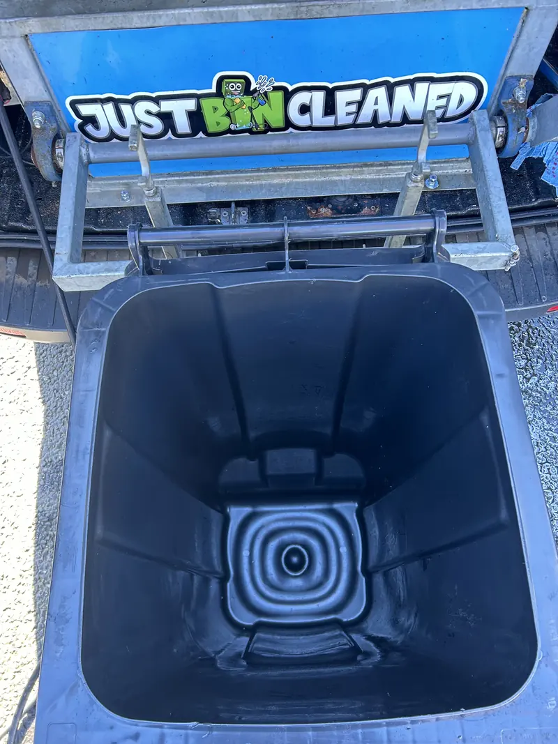 Clean black wheelie bin upside down on the JustBinCleaned washing rig