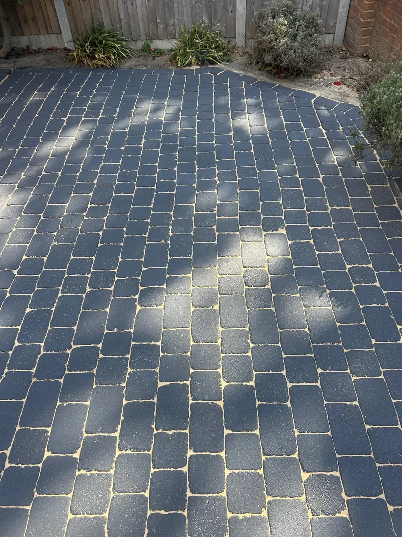 Dark grey block-paved driveway re-sanded with kiln-dried sand