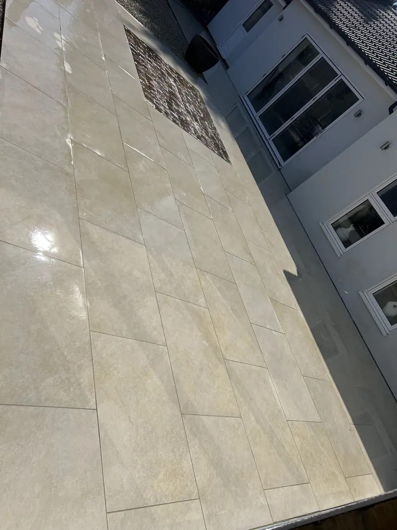 Pale porcelain patio next to a house