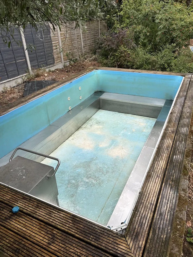 Garden plunge pool after cleaning, with clear blue lining