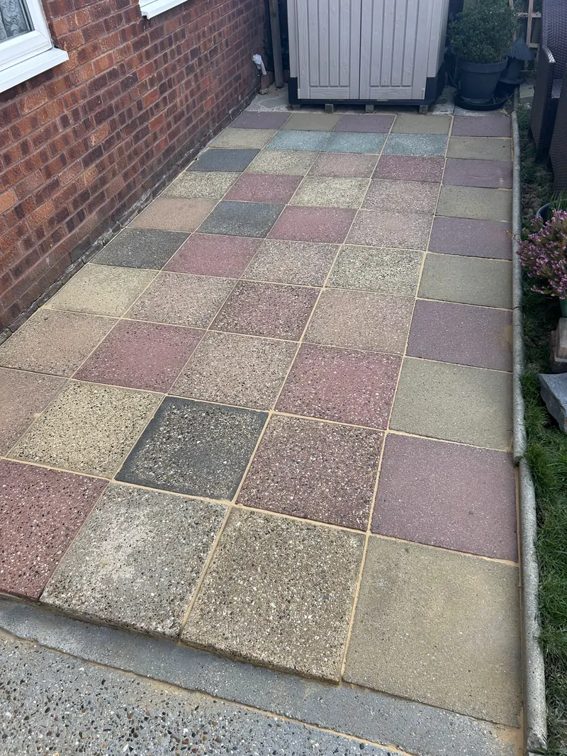 Multicoloured slab path beside a house