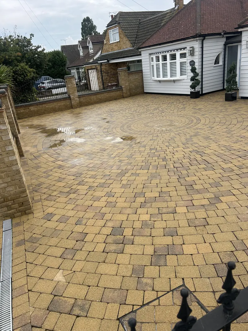 Buff circular-pattern block paving drive after cleaning, still wet